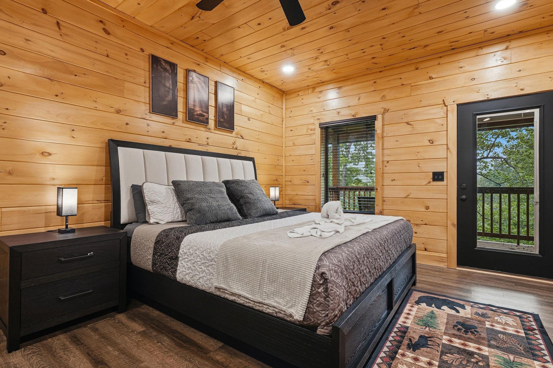 Drift into dreams in this cozy cabin bedroom, where rustic wood walls surround your plush bed and forest views await outside your window.