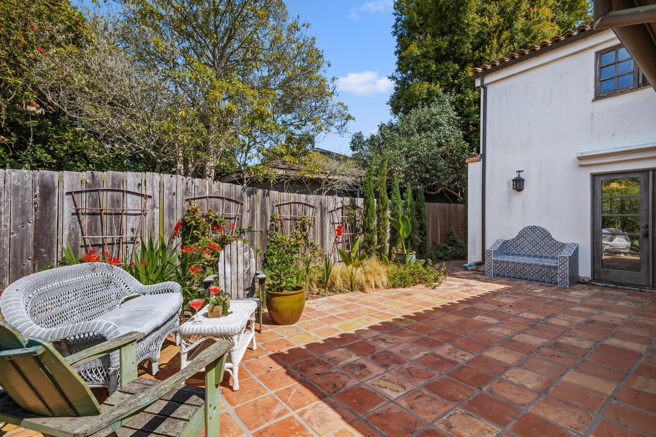 Stunning patio with mosaic tiles, outdoor seating, and an outdoor shower.