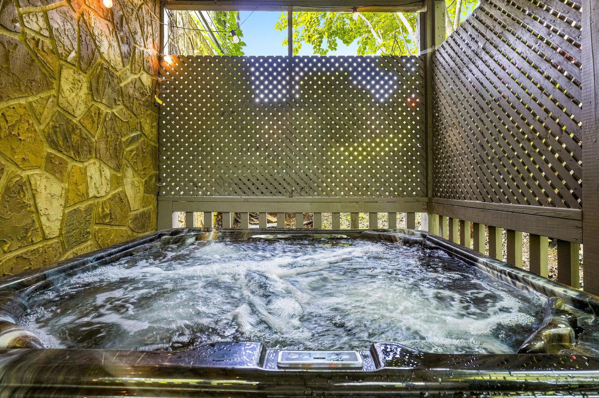 Slip into your private hot tub surrounded by leafy green views and decorative screens. Let the bubbling water melt away the day as sunlight filters through the lattice and vines overhead.