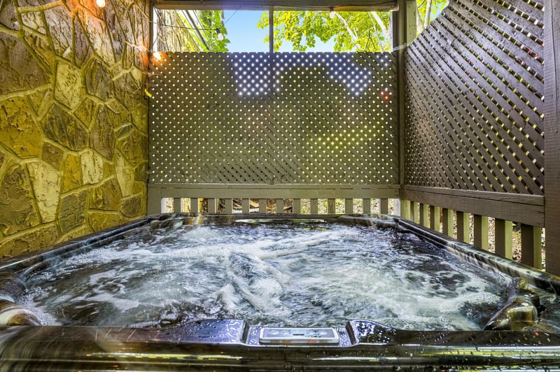 Slip into your private hot tub surrounded by leafy green views and decorative screens. Let the bubbling water melt away the day as sunlight filters through the lattice and vines overhead.