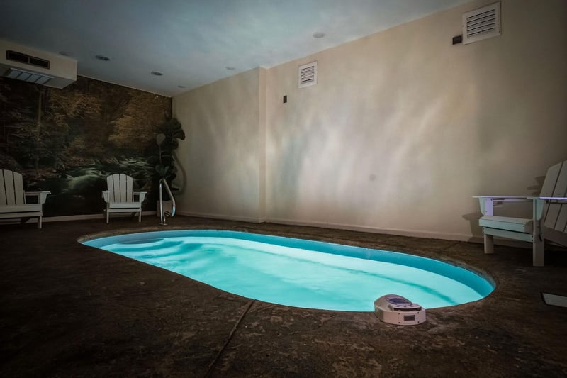 Your private indoor pool awaits, complete with lounge chairs and serene forest mural—perfect for unwinding after a day of adventure.