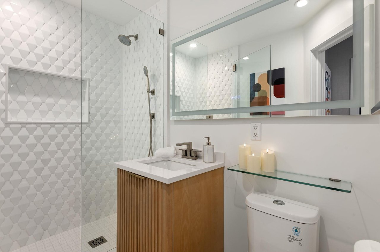 Shared bathroom with walkin shower.
