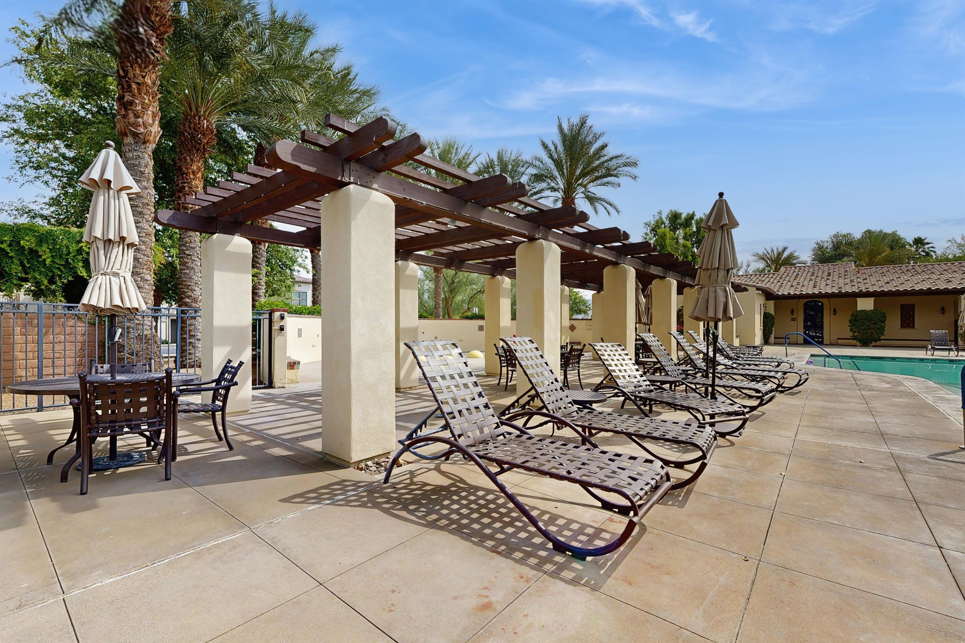 Shared sunloungers near the pool and hot tub.