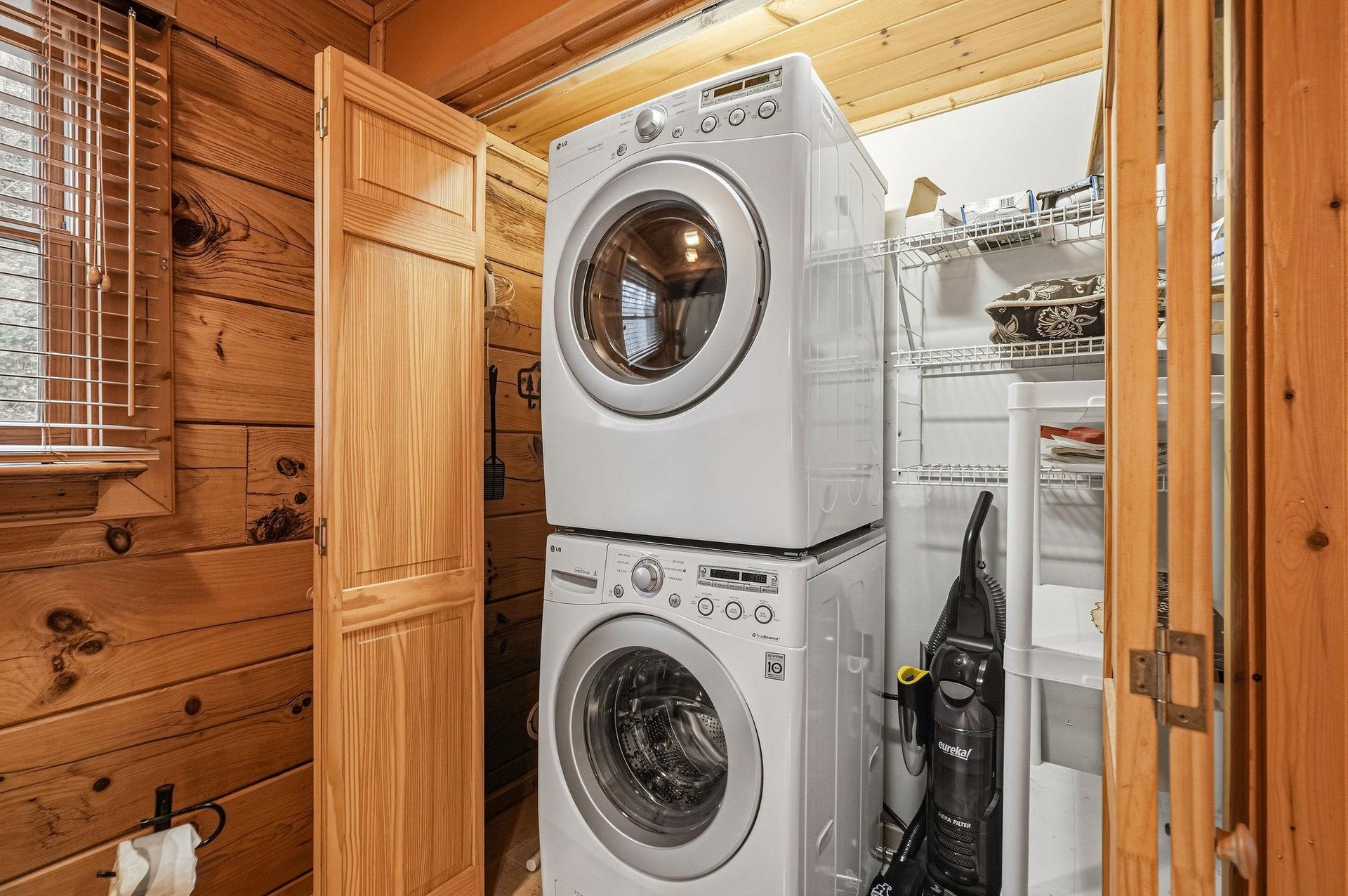 Keep your wardrobe fresh with fullsize washer and dryer tucked neatly in this organized utility space.