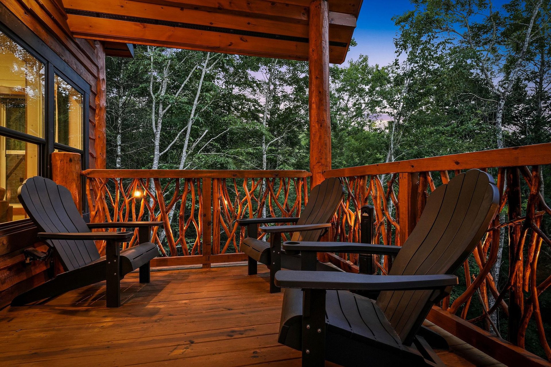 Settle into your private deck surrounded by towering trees, where rustic Adirondack chairs await peaceful evenings under the open sky. Warm wood tones and natures embrace create your perfect retreat.
