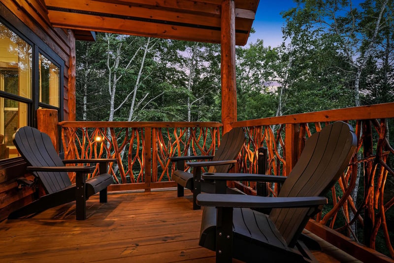 Settle into your private deck surrounded by towering trees, where rustic Adirondack chairs await peaceful evenings under the open sky. Warm wood tones and natures embrace create your perfect retreat.