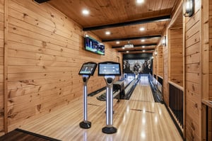 Your own private bowling lane with scoring screens awaits—warm wood walls, ambient lighting, and the thrill of strikes just steps from your door.
