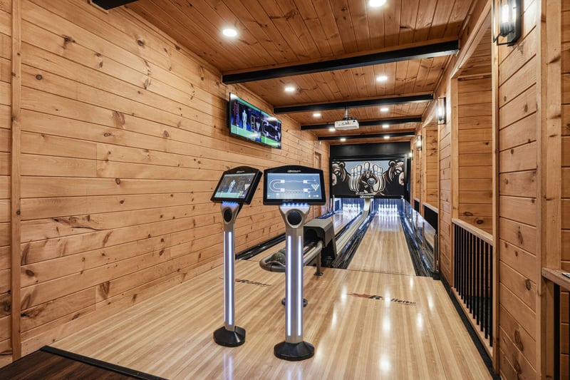 Your own private bowling lane with scoring screens awaits—warm wood walls, ambient lighting, and the thrill of strikes just steps from your door.
