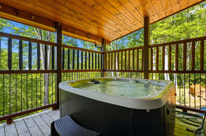 Slip into your private hot tub on this covered deck, surrounded by lush forest canopy for ultimate relaxation.