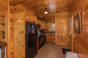 Kitchen with black appliances at Howlin in the Smokies, a 2 bedroom cabin rental located in Pigeon Forge