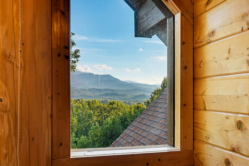 Open your window to breathtaking mountain vistas framed by warm wood walls—a peaceful retreat where nature becomes part of your everyday escape.