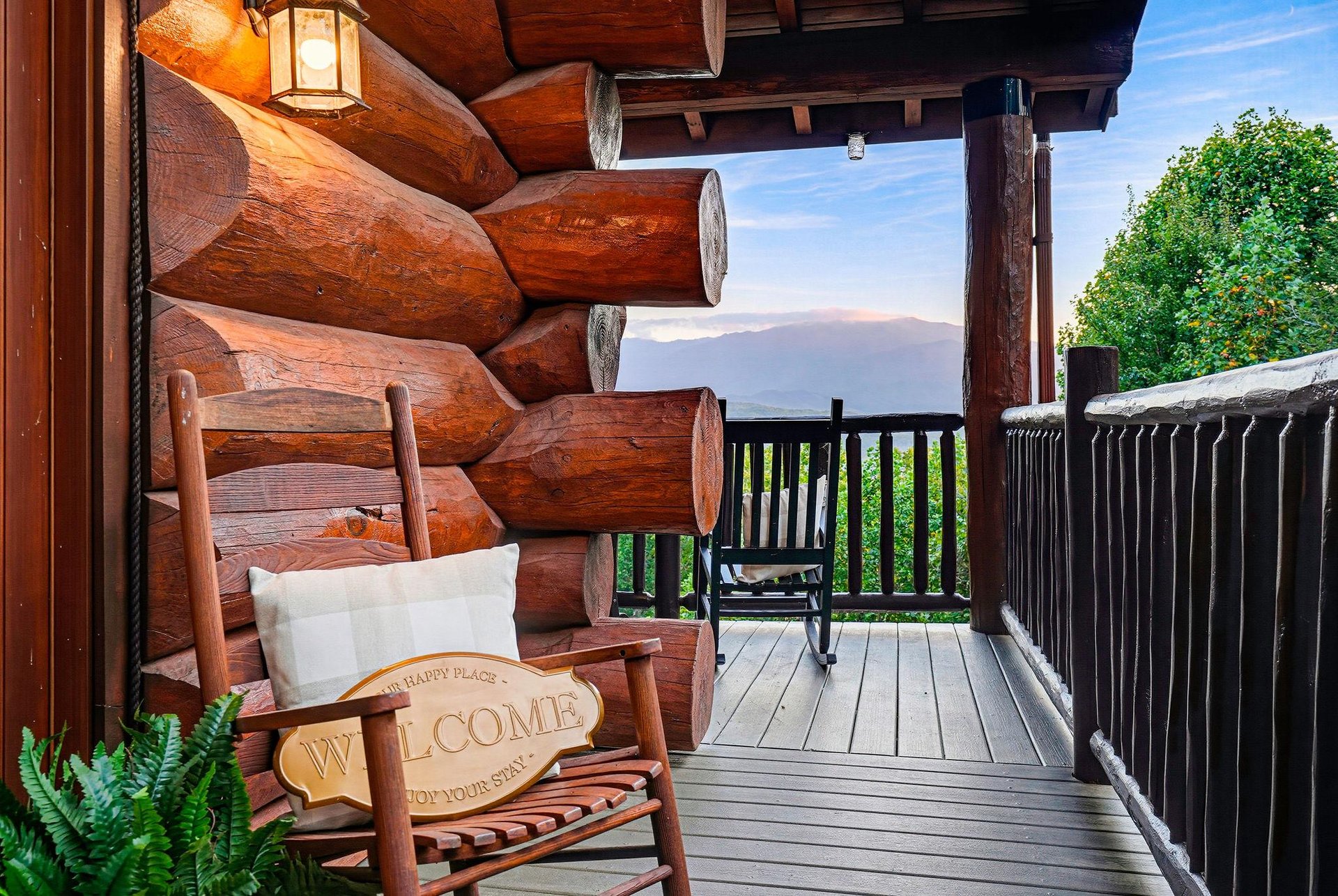 Picture yourself on this private covered deck, where a rustic log cabin meets serene mountain views. A welcoming rocking chair invites quiet moments as you take in the natural beauty surrounding your 