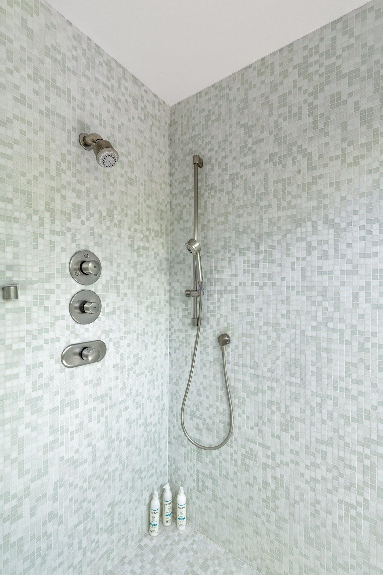 Standalone shower with its own sliding door to turn it into an indooroutdoor shower.