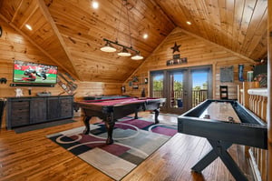 Your private game loft awaits with a pool table, shuffleboard, and bigscreen TV—perfect for unwinding after exploring nearby attractions.