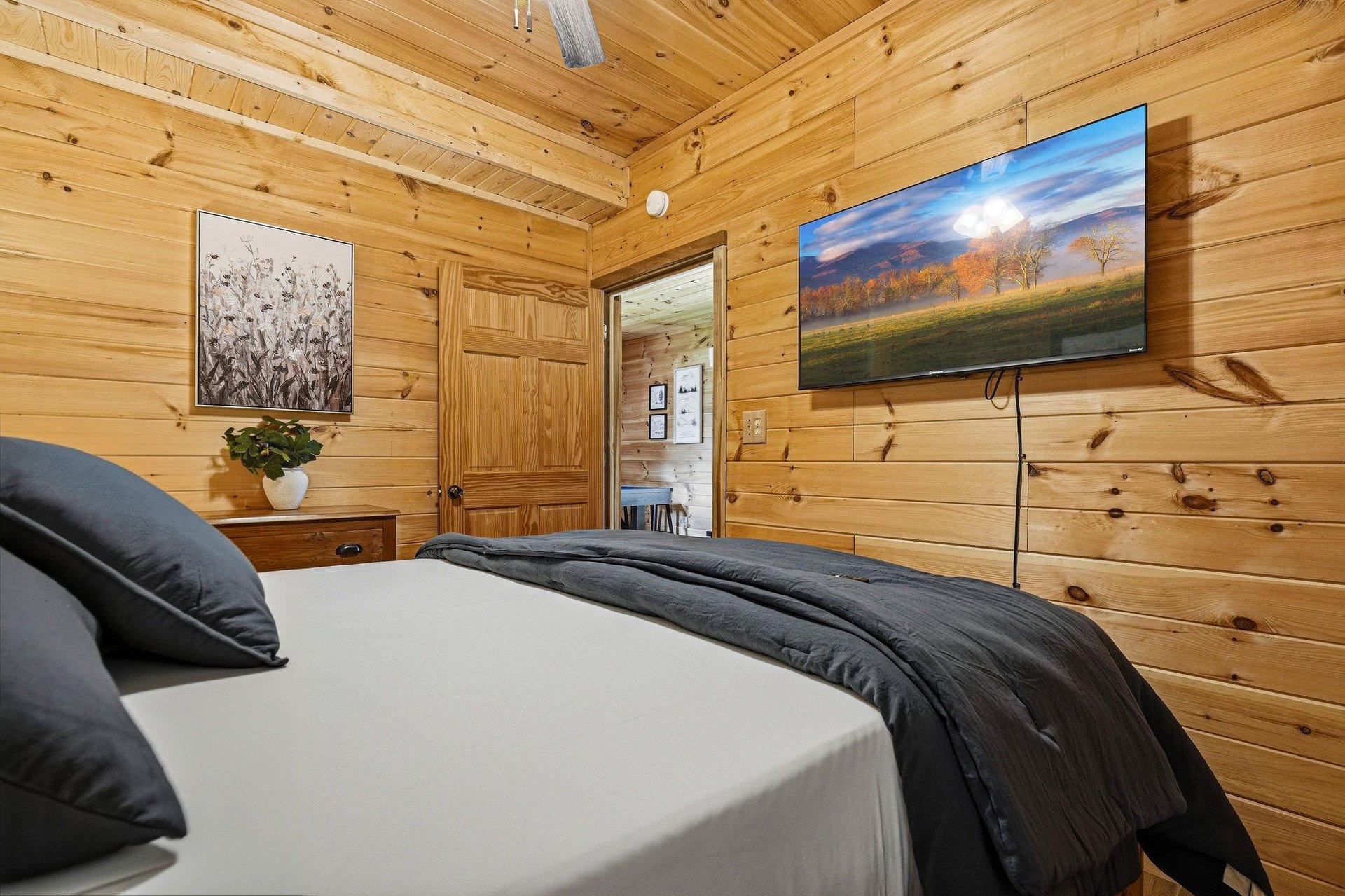 Sink into crisp linens under vaulted pine ceilings, where rustic charm meets modern comfort in your private retreat.