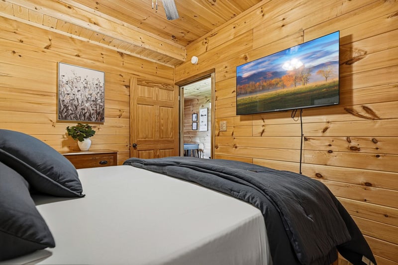 Sink into crisp linens under vaulted pine ceilings, where rustic charm meets modern comfort in your private retreat.