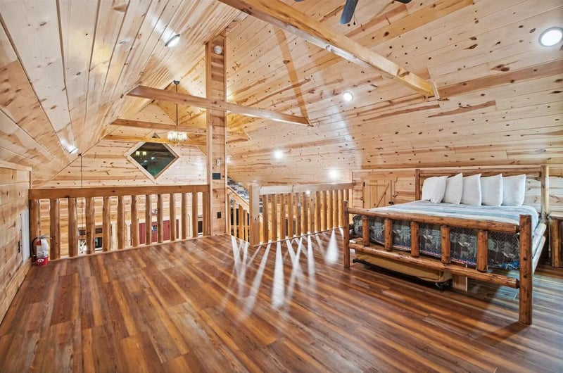Your rustic loft bedroom features warm wood beams and cozy log bed frame for peaceful mountain retreat nights.
