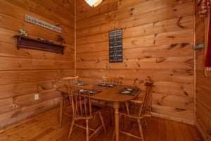 Dining table for four at Logans Smoky Den, a 2 bedroom cabin rental located in Pigeon Forge