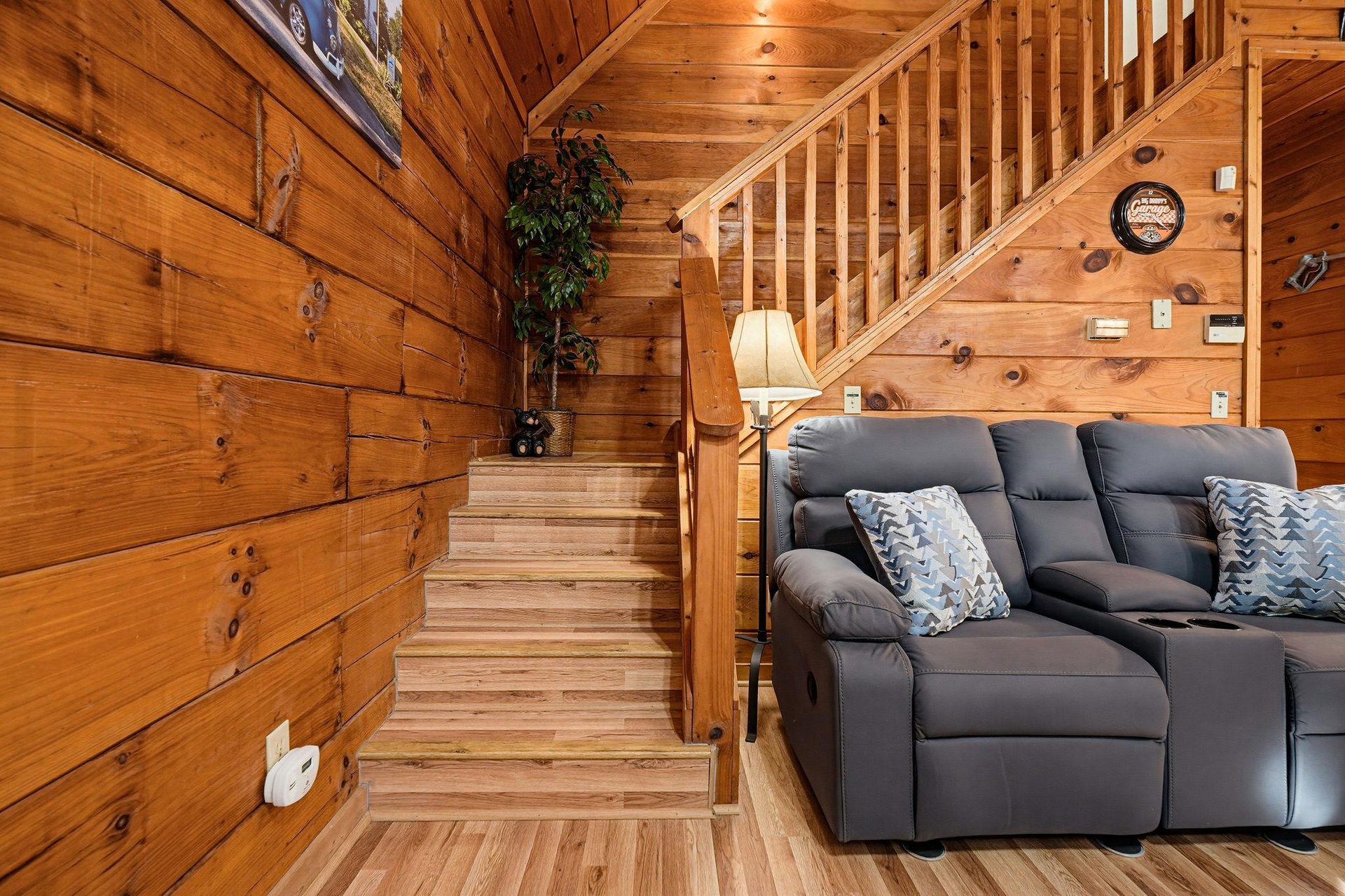 Sink into the plush recliner and feel the warmth of rich wood wrapping around you. Your cozy cabin retreat invites relaxation at every turn.