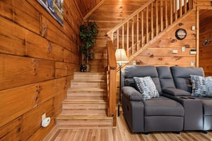 Sink into the plush recliner and feel the warmth of rich wood wrapping around you. Your cozy cabin retreat invites relaxation at every turn.