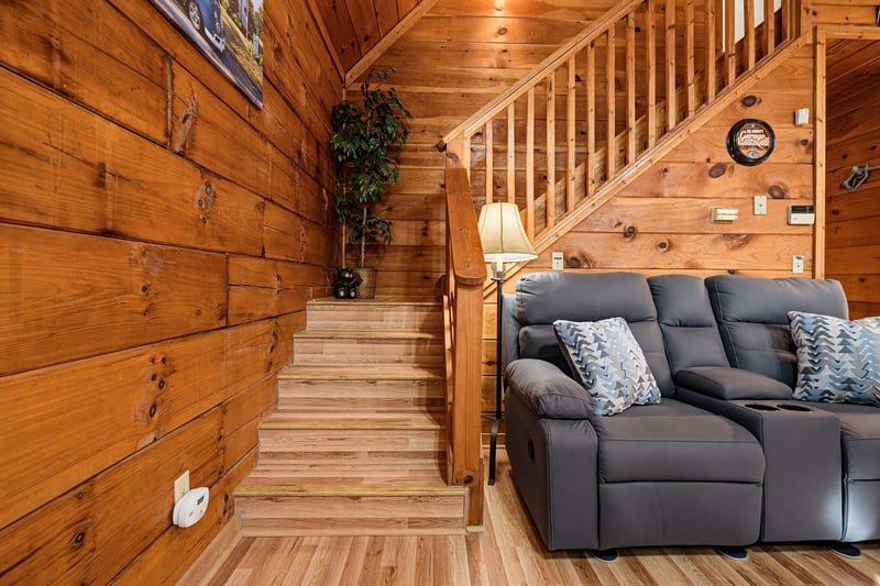 Sink into the plush recliner and feel the warmth of rich wood wrapping around you. Your cozy cabin retreat invites relaxation at every turn.