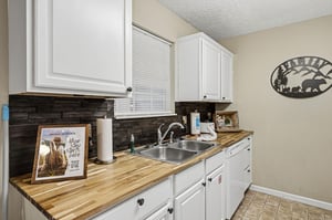 Your fullyequipped kitchen features warm wood countertops and modern appliances, perfect for preparing meals during your stay.
