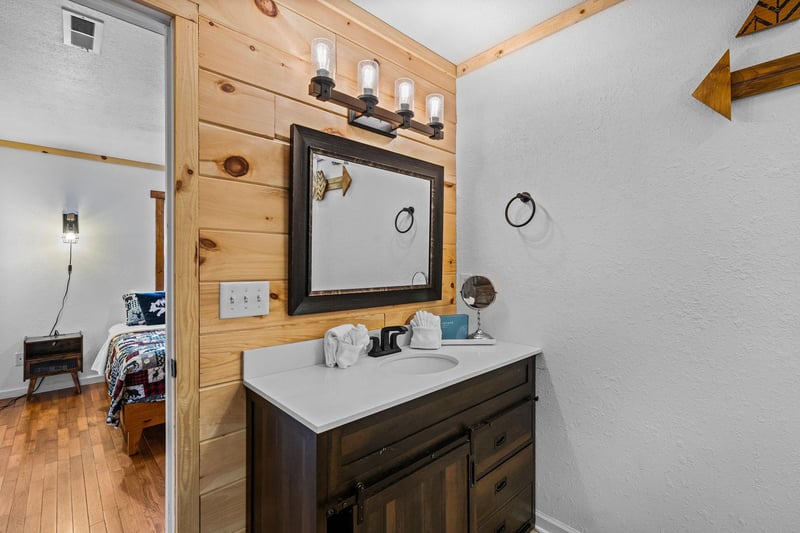 Bathroom attached to bedroom with single vanity