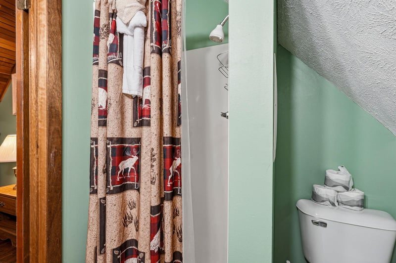 Step into your cozy bathroom with rustic charm, featuring a peaceful shower space and thoughtfully stocked amenities for your comfort.