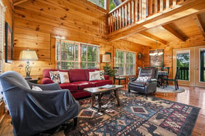Sink into rustic luxury in your openconcept living space, where warm log walls embrace rich leather seating and mountain charm.