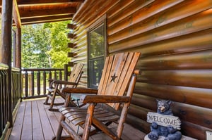 Rock gently on this covered deck, soaking in lush green views and the peaceful charm of your cabin retreat.