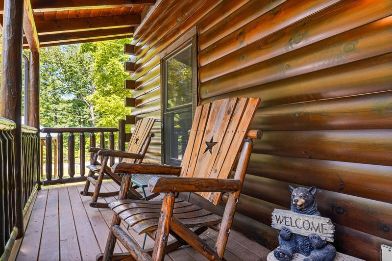 Rock gently on this covered deck, soaking in lush green views and the peaceful charm of your cabin retreat.