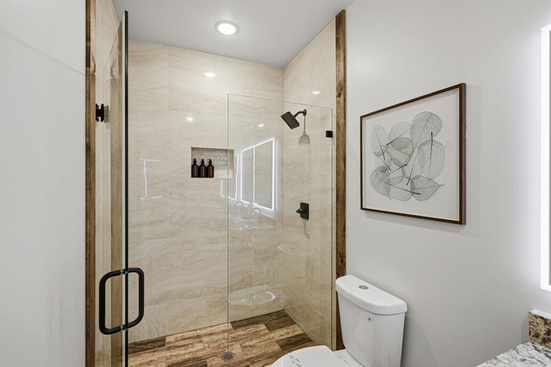 Unwind in your spalike bathroom featuring a spacious glass shower with rainfall head and elegant stone finishes.
