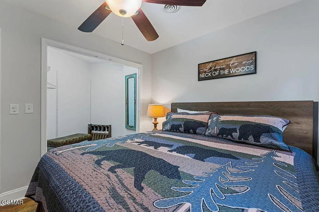 Sink into your cozy bedroom sanctuary with rustic woodland charm, complete with ceiling fan comfort and peaceful forestthemed decor.