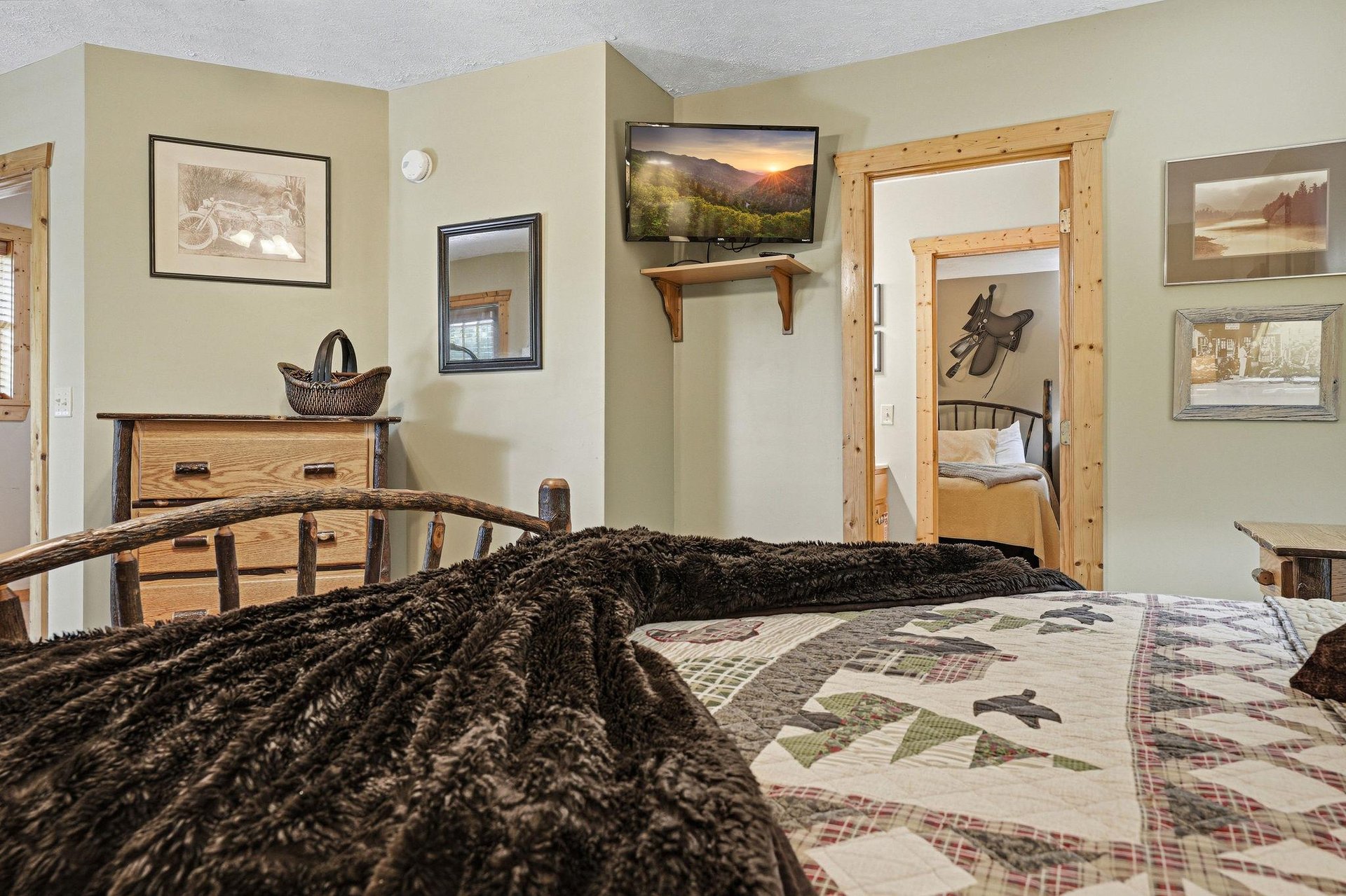 Sink into plush textures and rustic charm in your cozy bedroom. Natural wood accents and thoughtful touches create a warm retreat after a day of adventure.