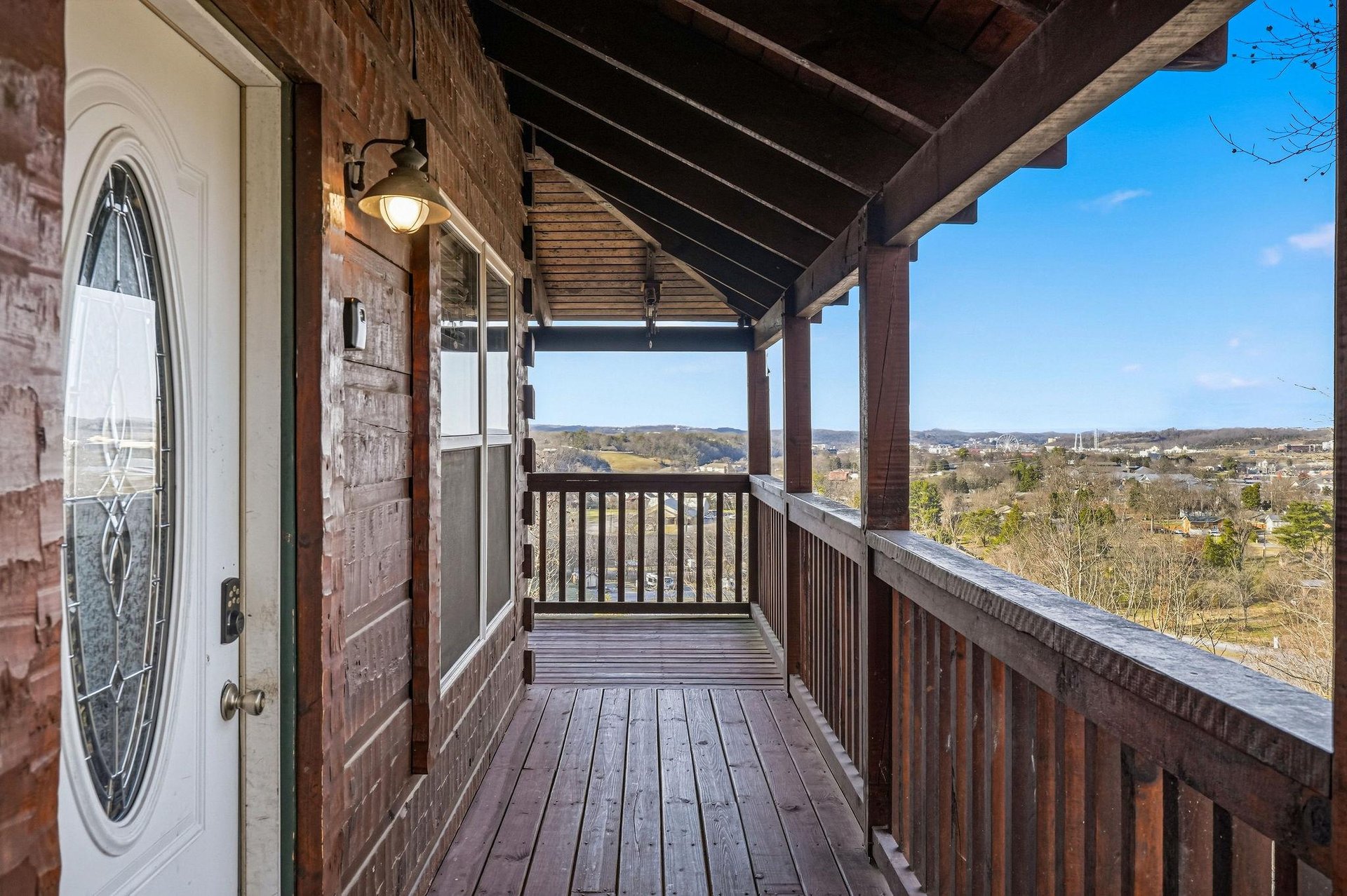 Step onto your private wooden balcony where breathtaking panoramic views stretch endlessly across rolling hills and countryside.