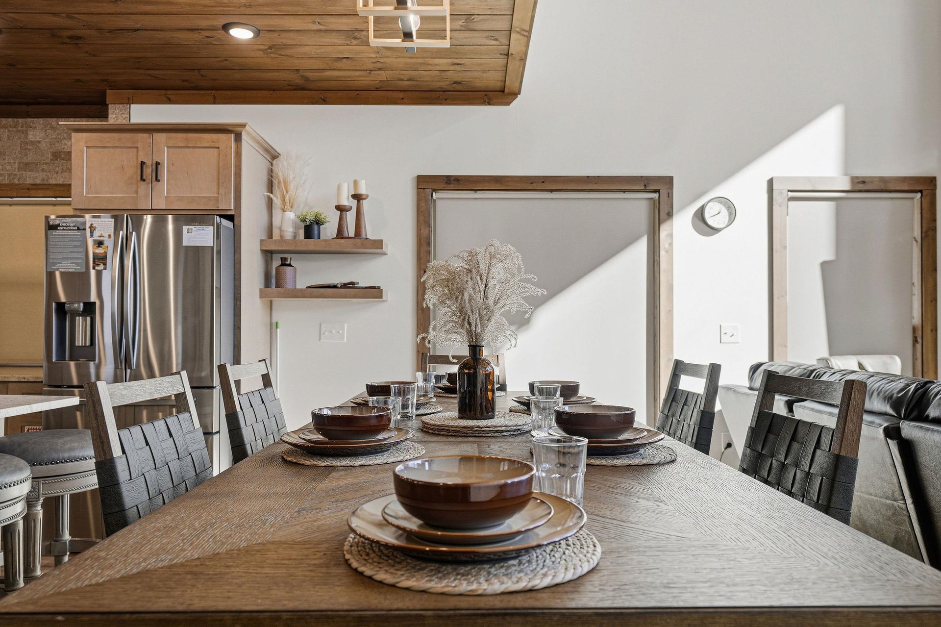 Your dining space invites memorable meals with rustic wooden table, modern chairs, and thoughtful details under warm ceiling beams.