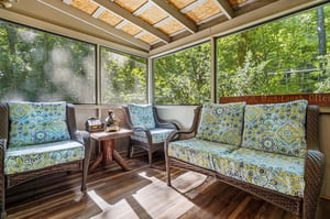 Your private screened porch invites you to unwind among vibrant cushions and peaceful forest views, a perfect spot for morning coffee or quiet reflection.