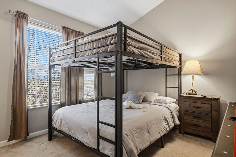 Sleep soundly in this stylish bunk bed setup with crisp linens and bedside conveniences for your restful retreat.