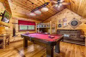 Pool table with bunk beds and couch