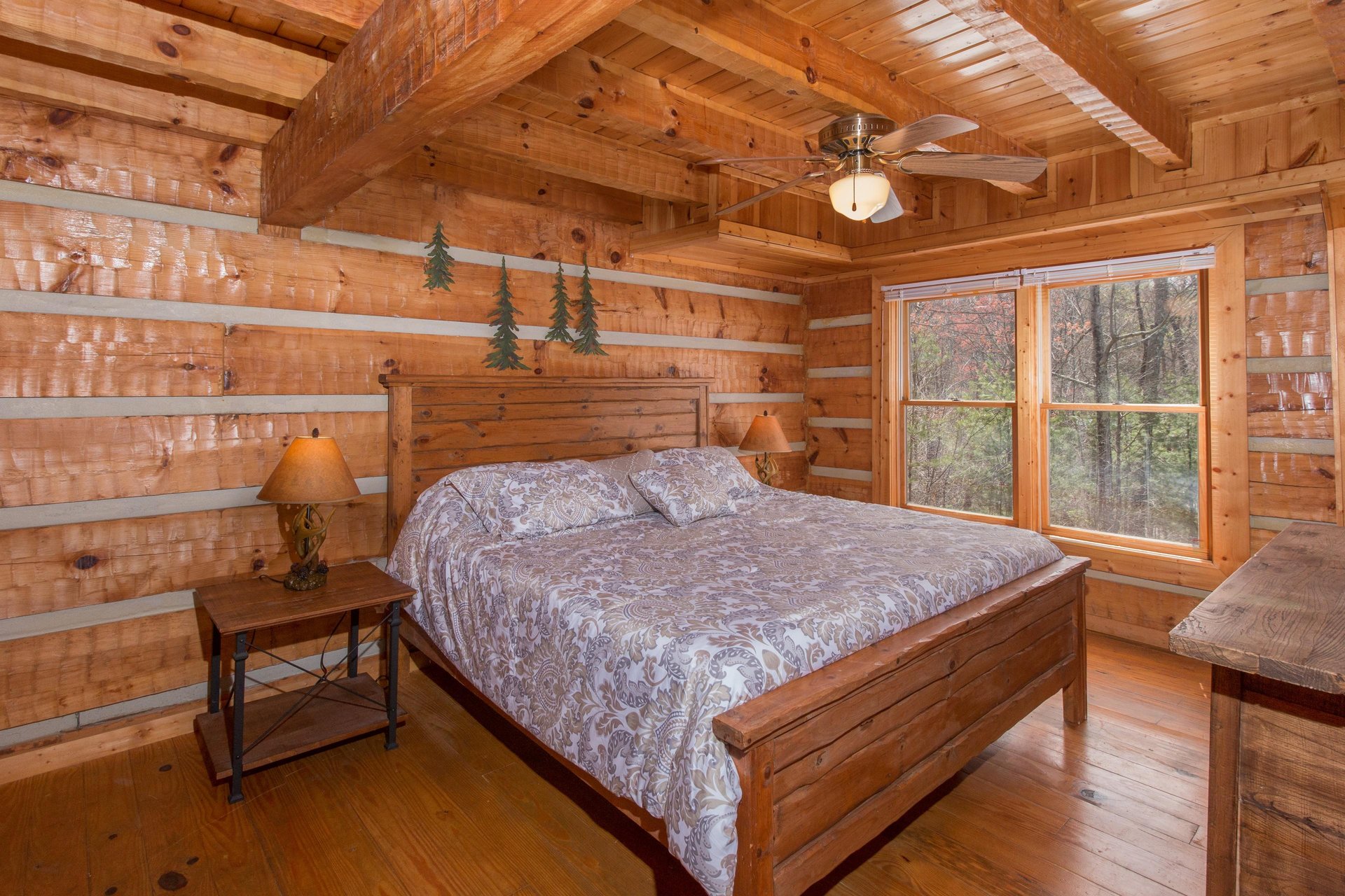 Bedroom with a bed, night stands, and lamps at EllaVation, a 3 bedroom cabin rental located in Gatlinburg