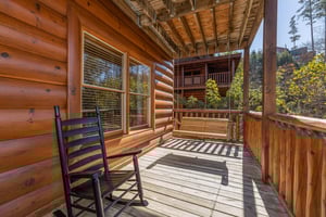 Porch swing and rocking chair on a deck at Bears Dont Bluff, a 3 bedroom cabin rental located in Pigeon Forge