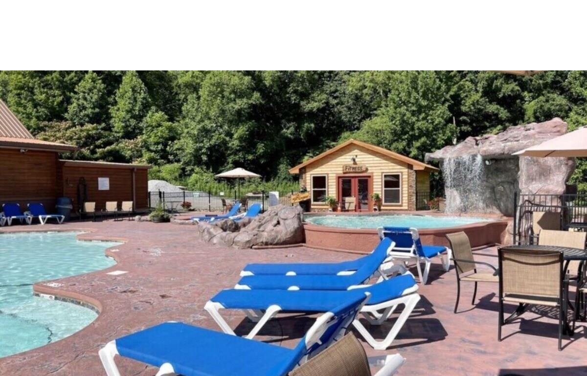 Soak up the sun on comfortable loungers by the sparkling pool, surrounded by lush greenery and charming stone features.