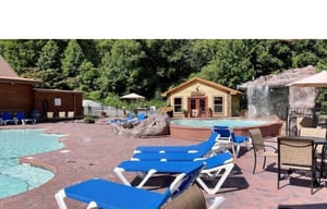 Soak up the sun on comfortable loungers by the sparkling pool, surrounded by lush greenery and charming stone features.