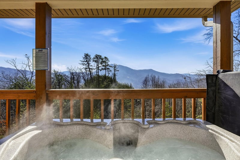 Soak in your private hot tub while taking in breathtaking mountain views from your covered deck.