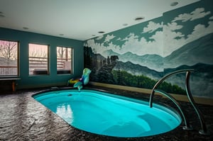 Dive into your private indoor oasis with stunning mountain mural and crystalclear pool—your perfect retreat awaits.