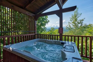 hot tub on a covered deck at angels majestic view a 3 bedroom cabin rental located in pigeon forge