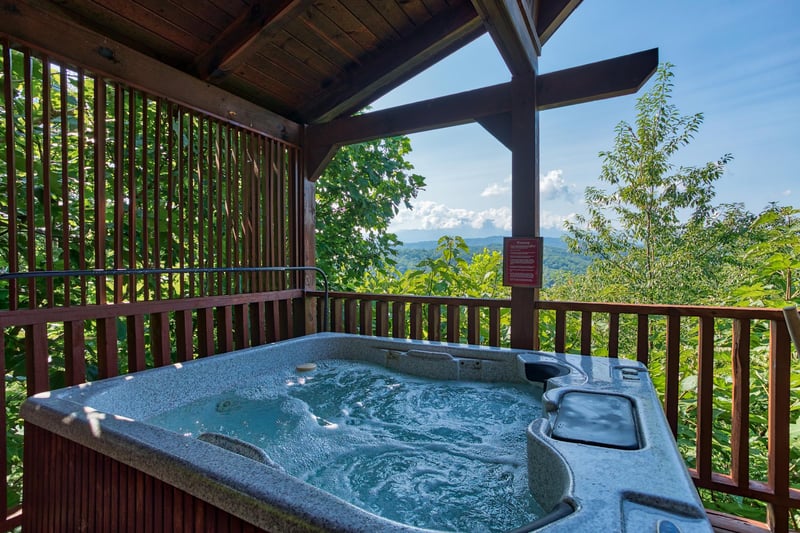 hot tub on a covered deck at angels majestic view a 3 bedroom cabin rental located in pigeon forge