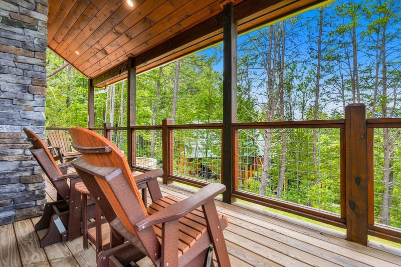 Sink into a comfortable chair on your private covered deck and let the lush forest canopy surround you—a peaceful retreat where fresh air and natural beauty are all yours to enjoy.