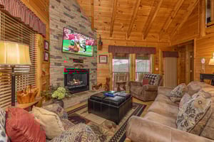 Fireplace and TV in a living room at Absolutely Wonderful, a 2 bedroom cabin rental located in Pigeon Forge