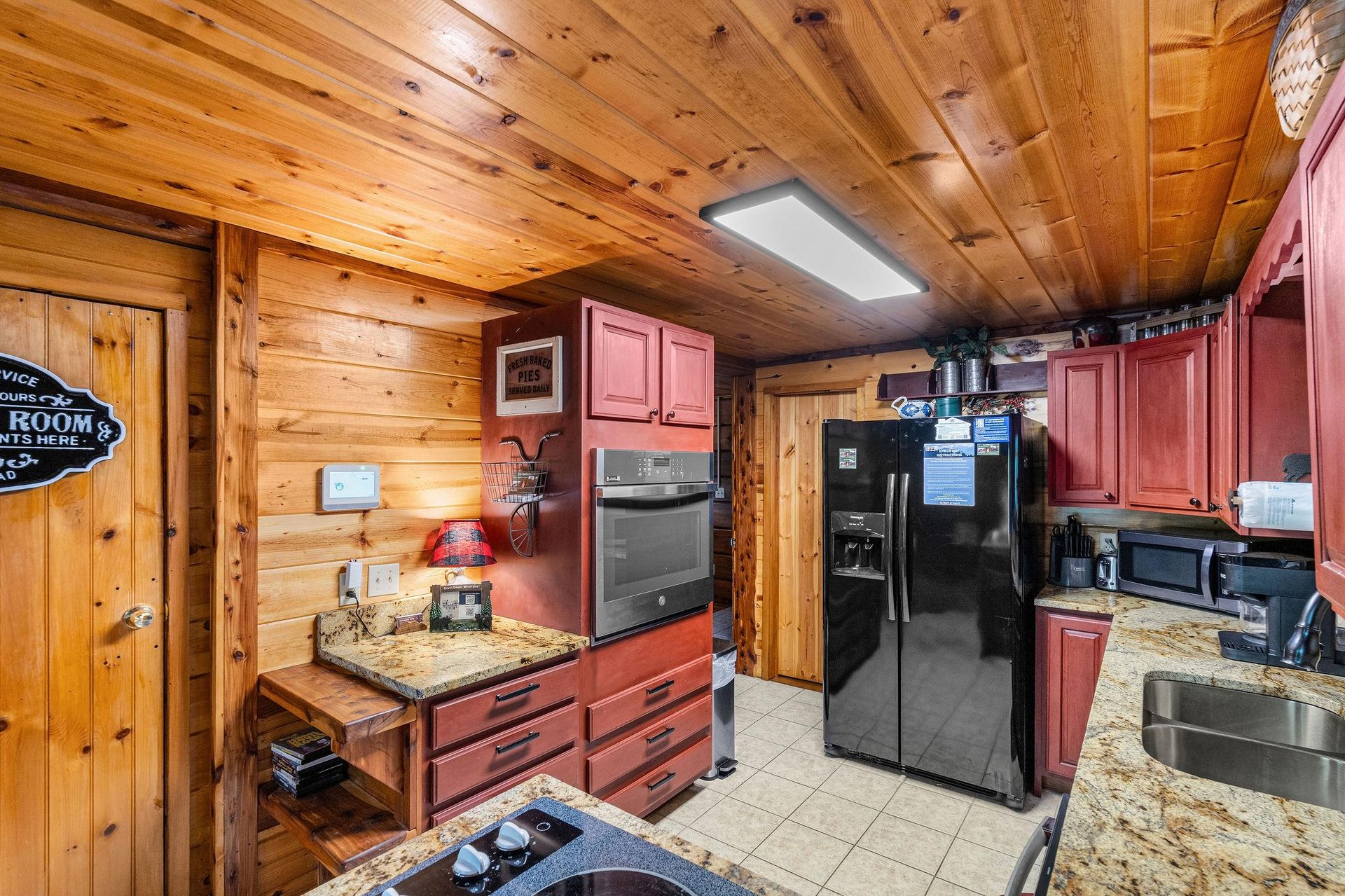 Full kitchen with red wood cabinets